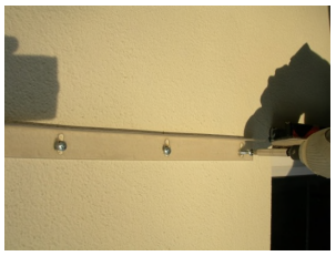 hidden bracket being mounted onto house using screws