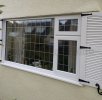 Traditional Louvre Shutters | Cathedral Top - Centre Mullion with added Decorative Hinges and S Hooks