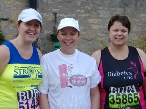 three smiling women in running gear 
