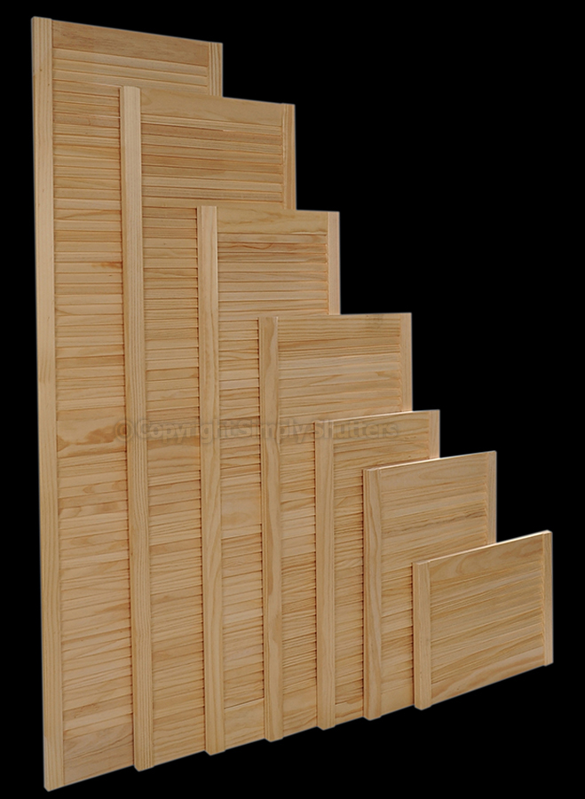 Pine louvre doors stood in height order 