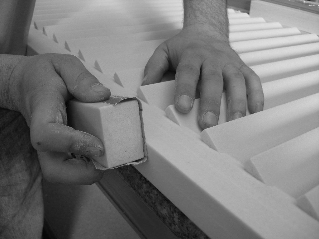 close up hand sanding louvre shutter