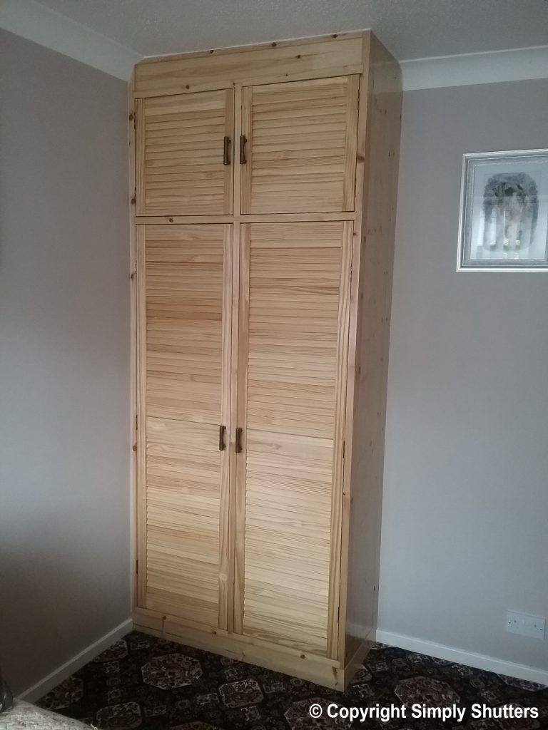 wardrobe with pine louvre doors on front 