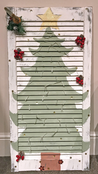 louvre door with a painted Christmas tree on the front 