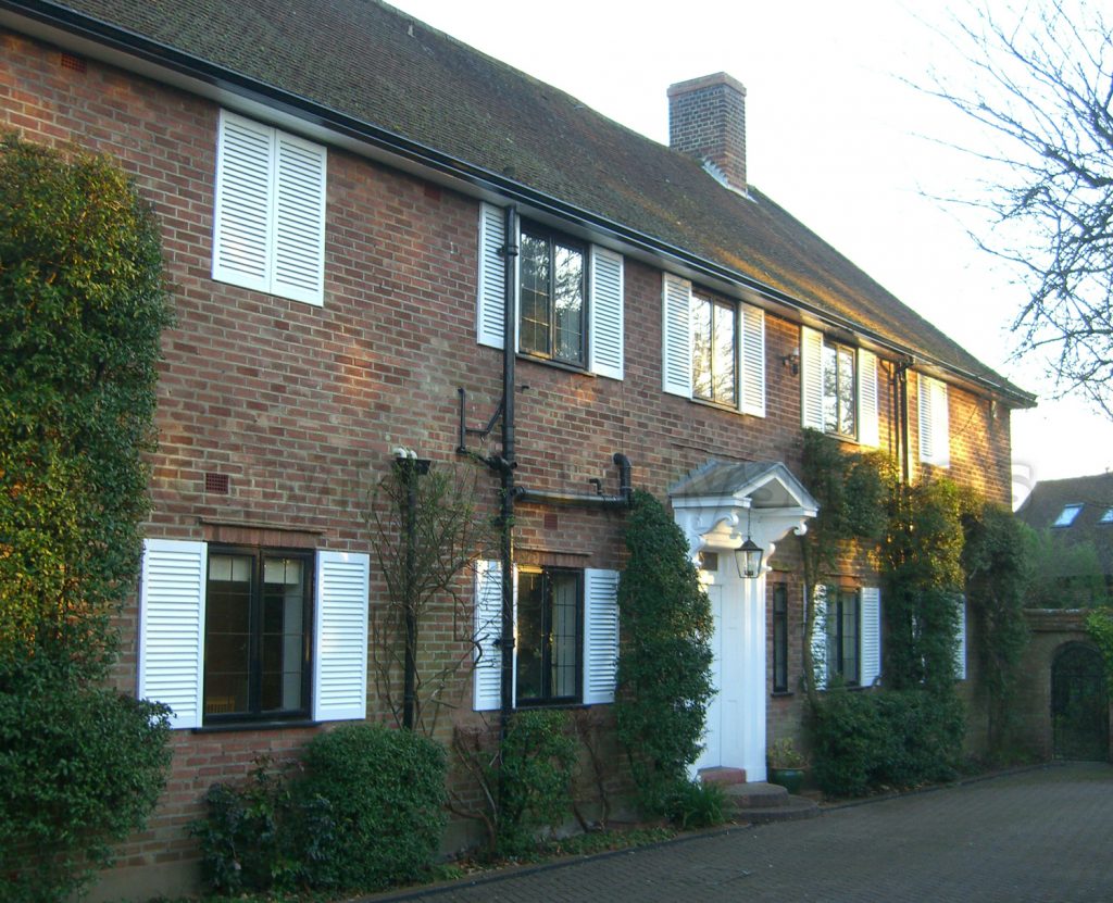 large house decorated with white louvre shutters 