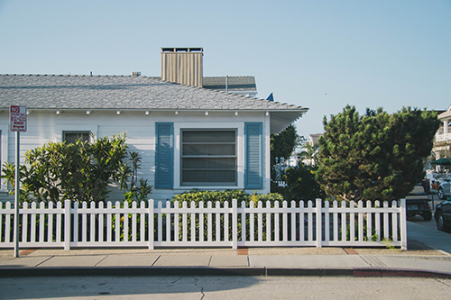 House with blue shutters and white picket fence 