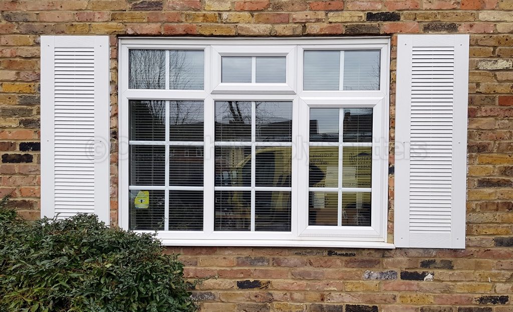 window with white louvre shutters 