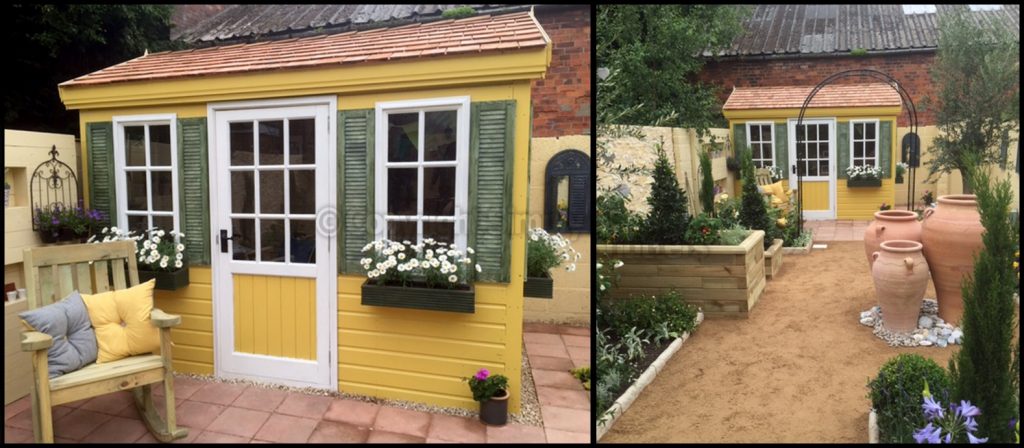 yellow garden shed with green shutters