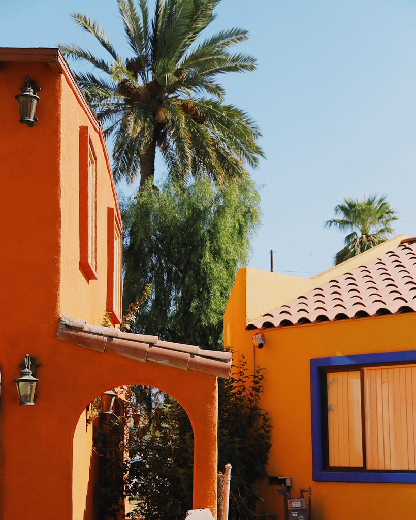 orange painted villa with palm tree