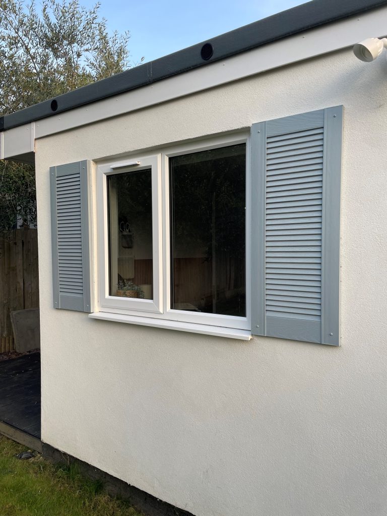 Grey shutters installed on window 