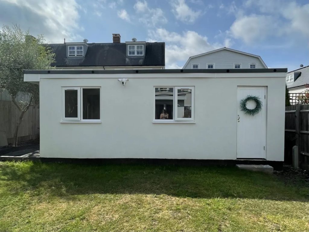 Small out building with 2 windows and door with reef. 