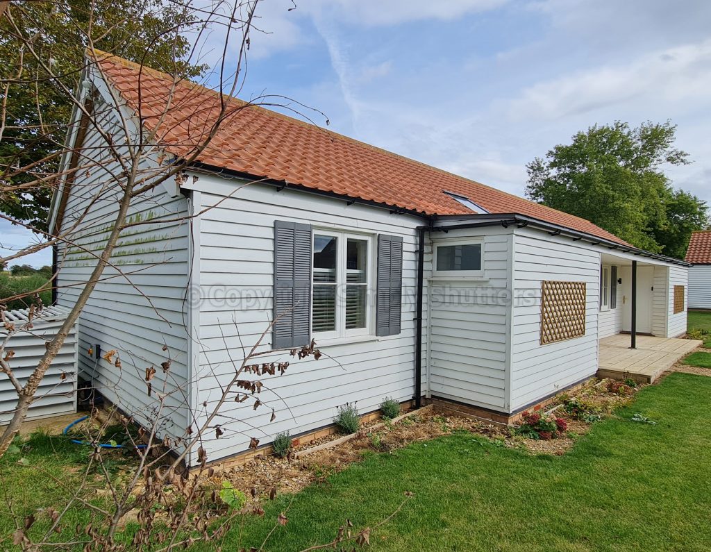 Side view of house with shutters installed on window 